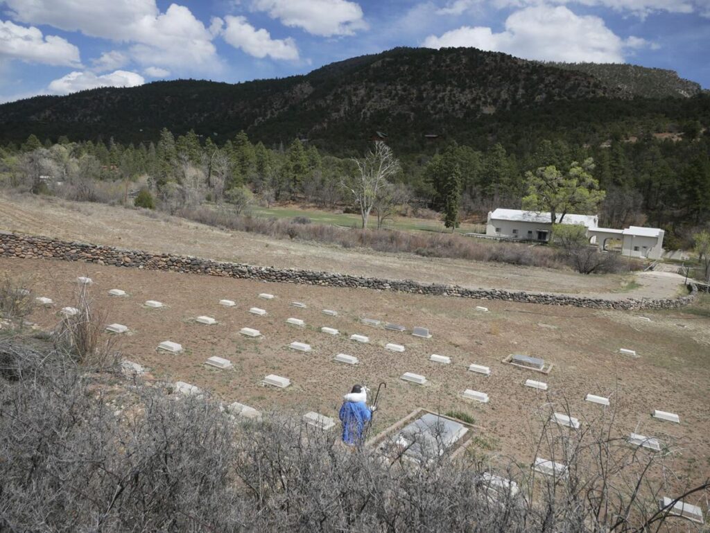 Headstones mark where priests are buried in a field on the Servants of the Paraclete's Lourdes Retreat just north of Jemez Springs. Matt Dahlseid / The New Mexican