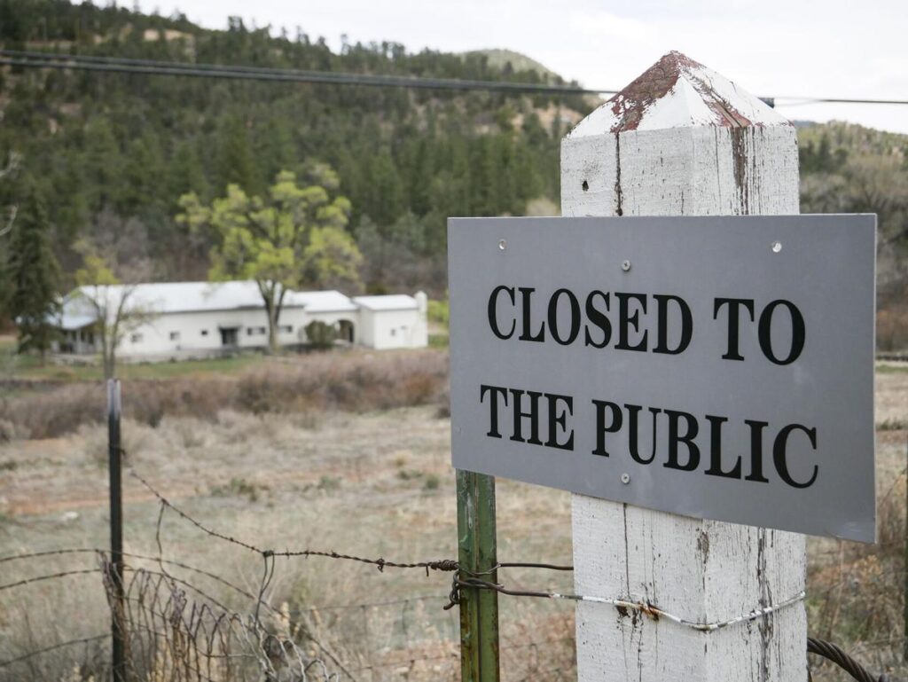 A sign deters entry to the Servants of the Paraclete’s Lourdes Retreat just north of Jemez Springs. Matt Dahlseid / The New Mexican