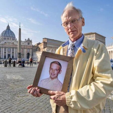 Phil Saviano in St Peter’s Square during the sexual abuse summit in late February 2019; he holds a photograph of himself at age 12, when he was being assaulted by Fr David Holley; photographer unknown.