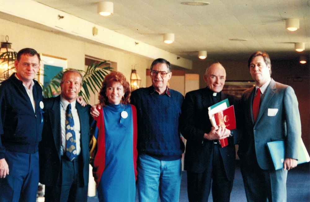 Jeanne Miller with speakers at the first VOCAL / Linkup Conference in Arlington Heights IL on October 16-18, 1992. Left to right: Tom Doyle, Jeff Anderson, Jeanne Miller, Richard Sipe, Fr. Andrew Greeley, and Jason Berry.