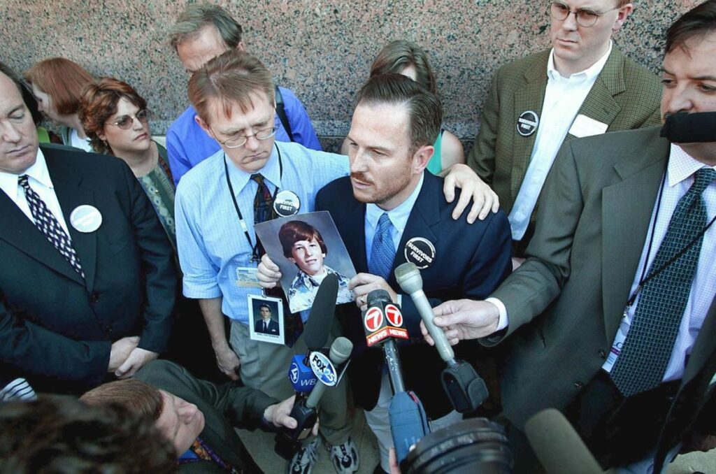 David Clohessy (2nd L), Mark Serrano (2nd R), and Paul Baier following the announcement that bishops had agreed to bar pedophile priests from acting as clerics at the United States Conference of Catholic Bishops in Dallas, June 14th, 2002.  Paul Buck / AFP