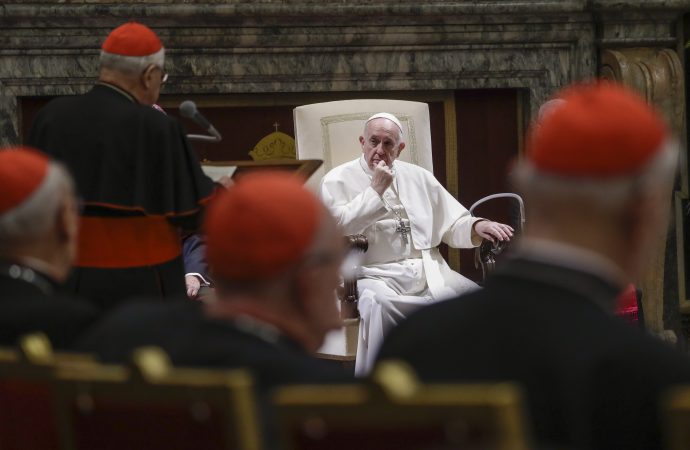 In this Dec. 21, 2019 file photo, Pope Francis listens to Cardinal Angelo Sodano, standing at left with back to camera, as he delivers his speech on the occasion of the pontiff's Christmas greetings to the Roman Curia, in the Clementine Hall at the Vatican. Pope Francis sent a message to Vatican-based cardinals on Friday about his intent to hold them accountable for criminal misconduct, removing the legal obstacles that had prevented them from ever being prosecuted by the Vatican’s criminal tribunal. (Credit: AP Photo/Andrew Medichini, Pool.)