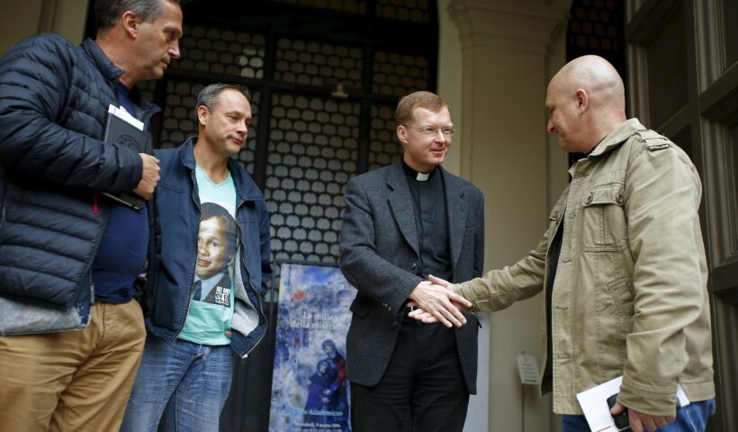 Jesuit Father Hans Zollner, a leading Vatican official dealing with clergy sexual abuse in the church, is pictured in a file photo greeting Andrew Collins, David Ridsdale and Peter Blenkiron at the Pontifical Gregorian University in Rome. The three men said they were child sex abuse victims in Australia. (Credit: Tony Gentile / Reuters via CNS.)