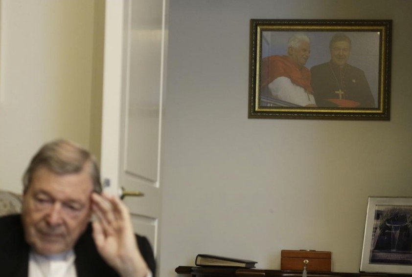 A picture of Pope Benedict XVI and Australian Cardinal George Pell taken in Sydney during the 2008 World Youth Day hangs on a wall of Cardinal Pell's home while he is interviewed by The Associated Press at the Vatican, Thursday, May 20, 2021. Pell, who was convicted and then acquitted of sex abuse charges in his native Australia, is spending his newfound freedom in Rome. (AP Photo / Gregorio Borgia)