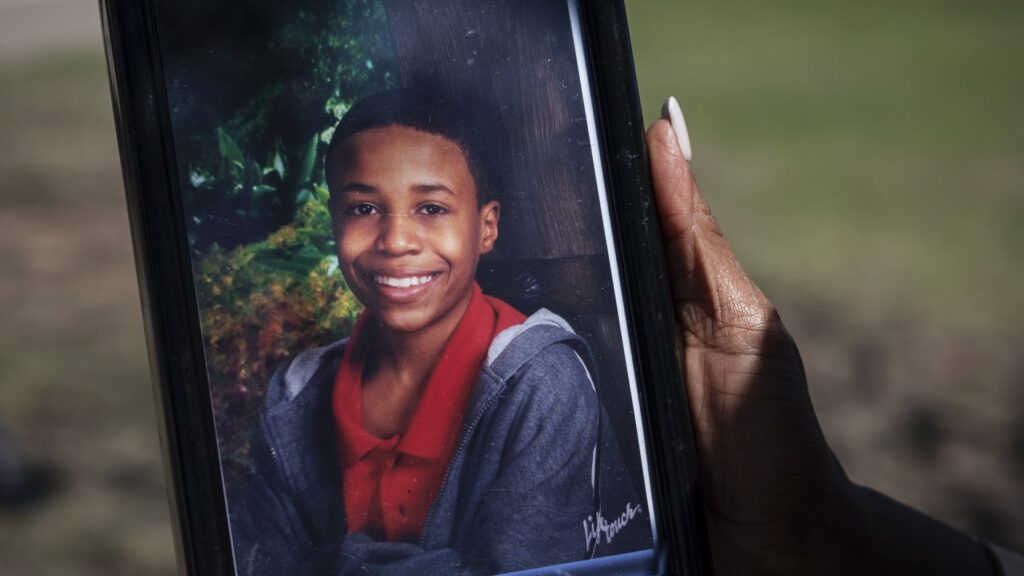 Donna Fields holds a photo of her son Marcus Bell Jr. Bell says that when he was 13, he was raped by Inspiring Body of Christ Church Pastor Rickie Rush. Fields and her sister say Rush also sexually abused them starting when they were teenagers.(Ben Torres / Special Contributor)