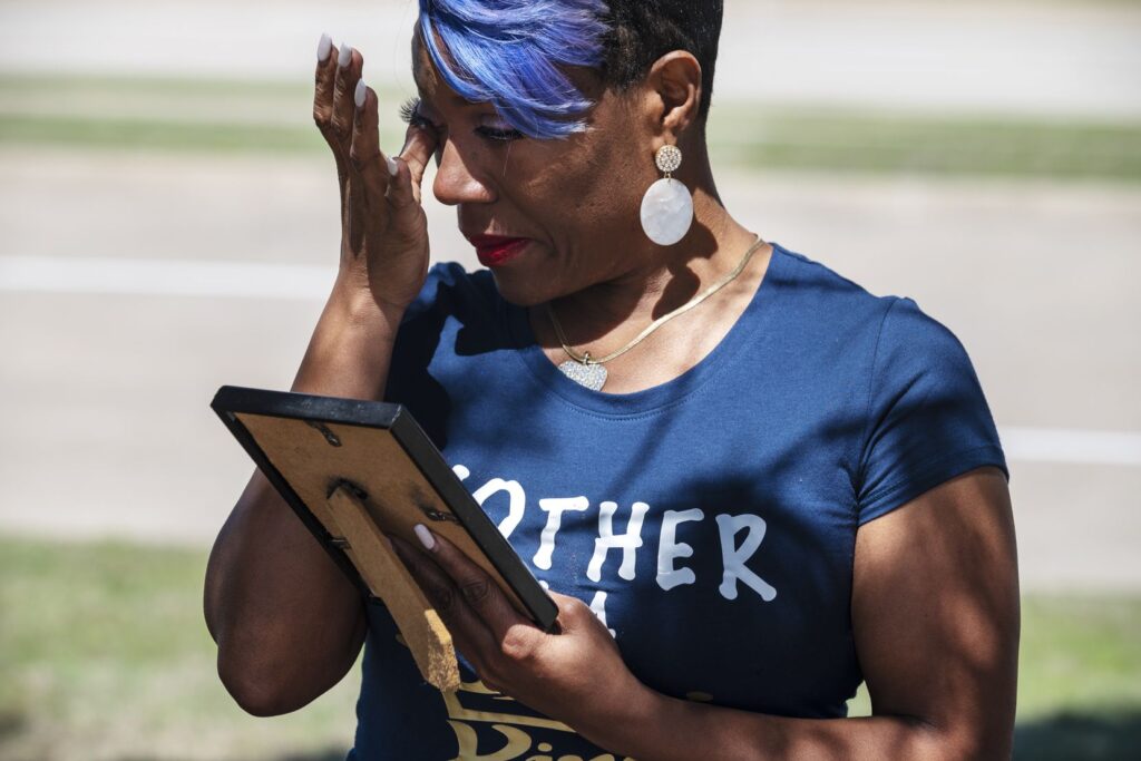 Donna Fields, 47, wipes away tears while looking at a photo of her son Marcus Bell Jr., when he was 12 years old. Bell says he was raped by Pastor Rickie Rush when he was 13. Fields and her sister also say Rush sexually assaulted them.(Ben Torres / Special Contributor)