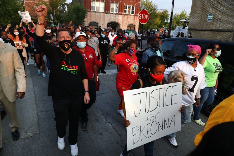 By CHRIS SWEDA / CHICAGO TRIBUNE The Rev. Michael Pfleger of St. Sabina Church leads people from Racine Avenue and 79th Street, where they shut down the intersection during rush hour in protest following the announcement of charges in the Breonna Taylor case on Sept. 23, 2020. (Chris Sweda / Chicago Tribune)