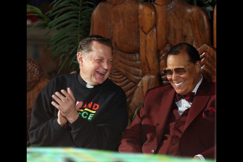 By TERRENCE ANTONIO JAMES / CHICAGO TRIBUNE The Rev. Michael Pfleger, left, shares a laugh with Nation of Islam leader Louis Farrakhan as Farrakhan prepares to speak to people gathered at St. Sabina Church in Chicago on May 9, 2019. Farrakhan was invited to speak after he was banned from the social media platforms Facebook and Instagram. (Terrence Antonio James / Chicago Tribune)