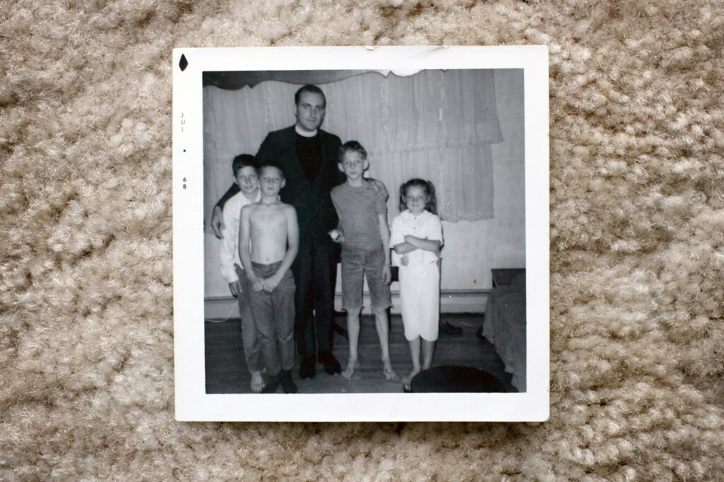Father Richard Lavigne with Joe Croteau (under his arm) Danny Croteau (second from left) Michael Croteau (second from right) and their sister Jackie Croteau, in a photo from 1968, pictured in Springfield, Mass., on Oct. 24, 2003.Dominic Chavez / Boston Globe via Getty Images file