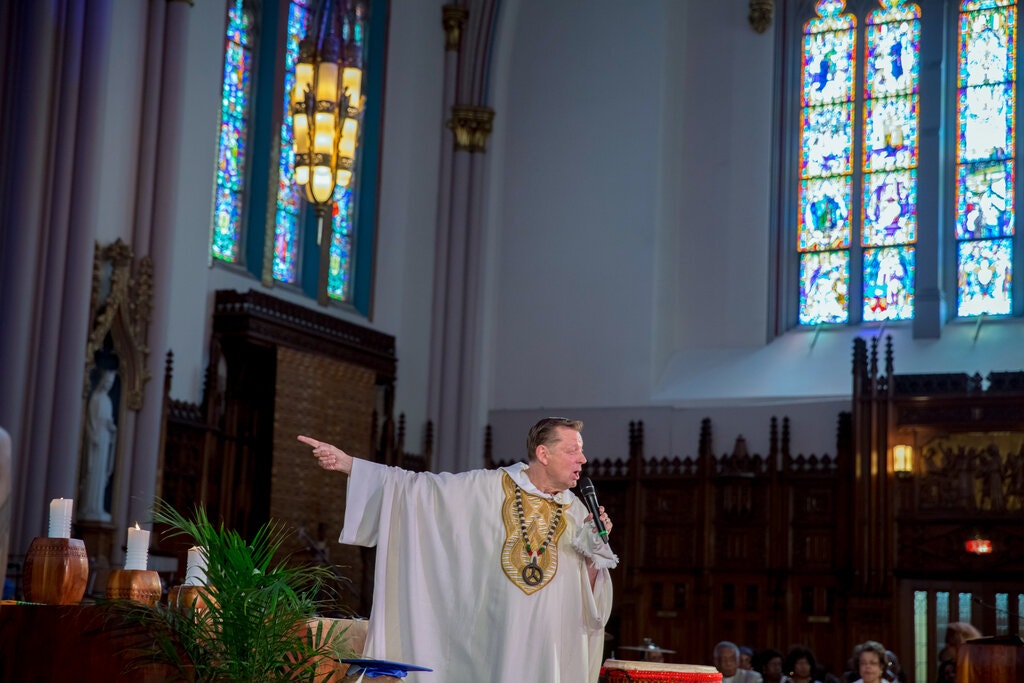 The Rev. Michael Pfleger delivering a sermon in 2016 at St. Sabina in Chicago. He is being reinstated to the parish next month.Credit...Whitney Curtis for The New York Times