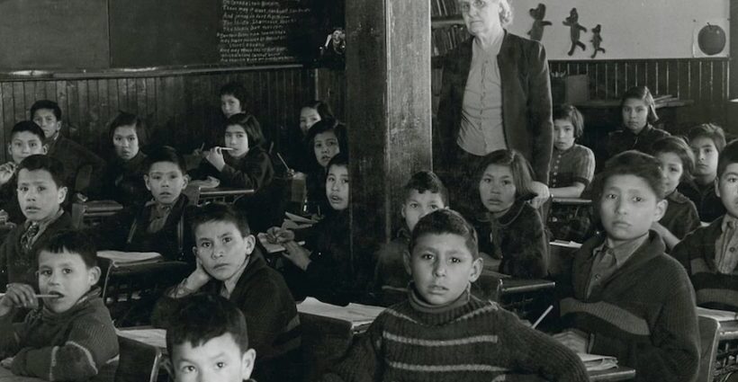 Students at their desks in in 1945 with their teacher at All Saints Indian Residential School in Lac la Ronge, Sask., where use of the Cree language was strictly forbidden. Photo: Library and Archives Canada)