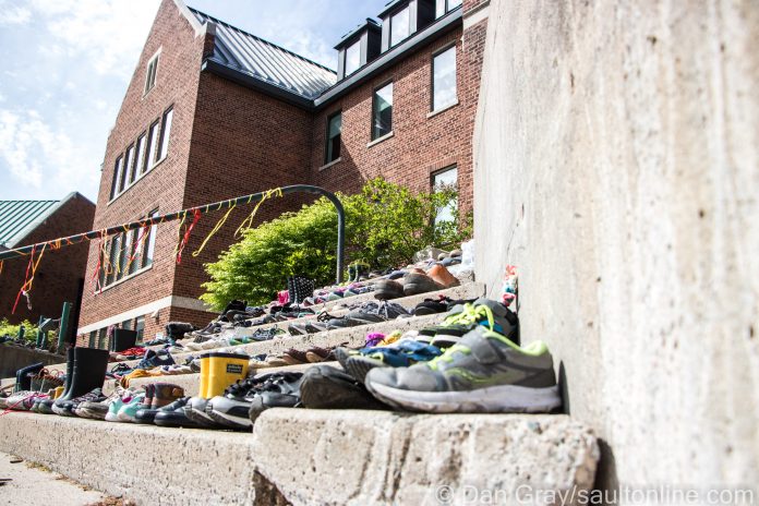 Hundreds of shoes have been placed on the steps of Shingwauk Hall, May 30, 2021 (Dan Gray / SaultOnline.com)