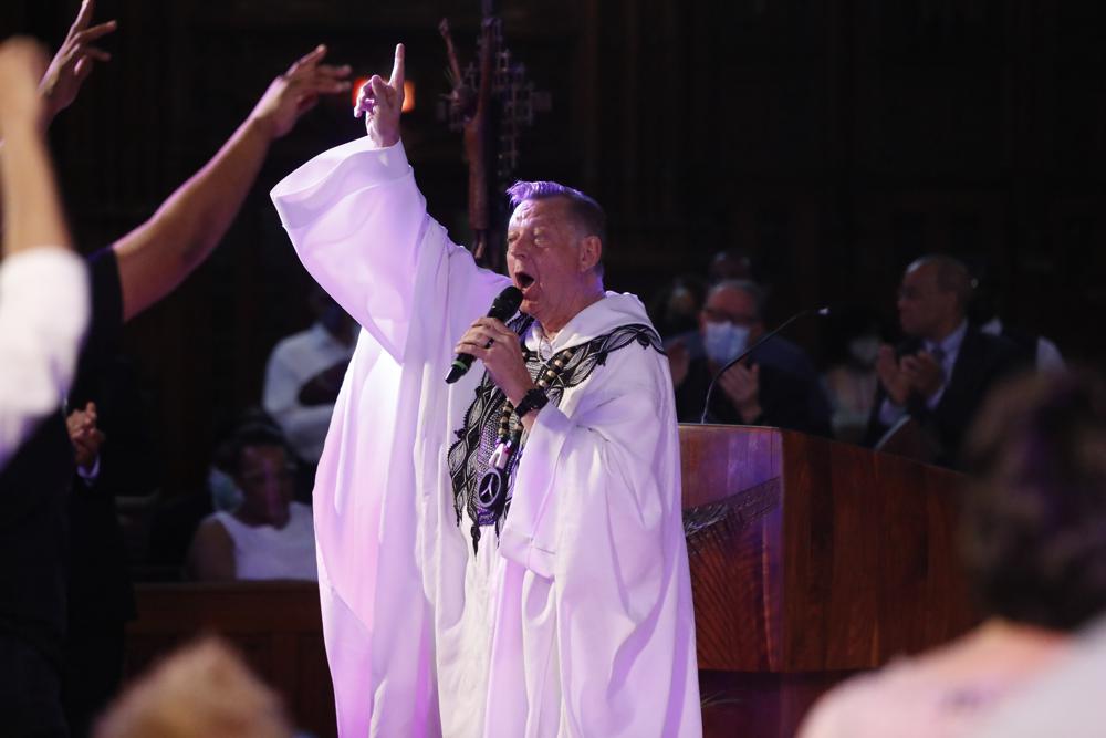 Rev. Michael Pfleger conducts his first Sunday church service as a senior pastor at St. Sabina Catholic Church following his reinstatement by Archdiocese of Chicago after decades-old sexual abuse allegations against minors, Sunday, June 6, 2021, in the Auburn Gresham neighborhood in Chicago. (AP Photo/Shafkat Anowar)