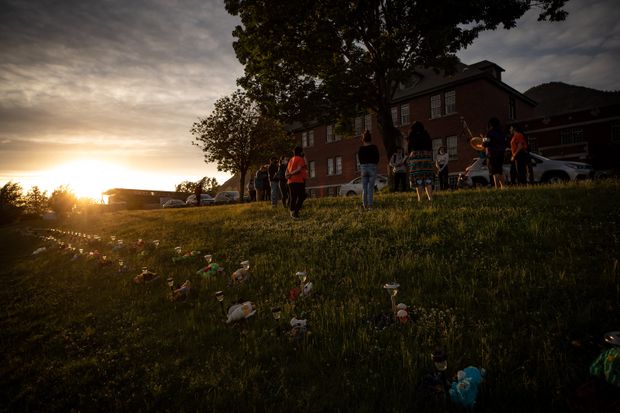 A group of youths lead a group drumming and singing at sunset outside the former Kamloops Indian Residential School, to honour the 215 children found in Kamloops on June 4, 2021.