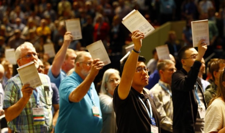 Messengers hold up an Southern Baptist Convention abuse handbook while taking a challenge to stop sexual abuse during the annual meeting on June 12, 2019, in Birmingham, Alabama (RNS / Butch Dill)