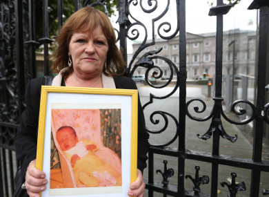 Terri Harrison pictured with a photo of her baby Niall, at a protest outside Leinster House in 2014. -- Sam Boal/RollingNews.ie