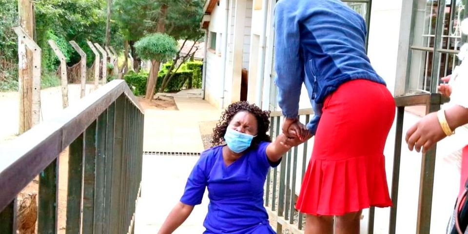 Veronica Musali Mutua (left) goes down in tears outside a Kitui court on June 16, 2021 following the acquittal of a former Catholic priest, Japheth Mwove Kimanzi, who had been charged with attempting to kill her and her child in 2015.  Kitavi Mutua | Nation Media Group