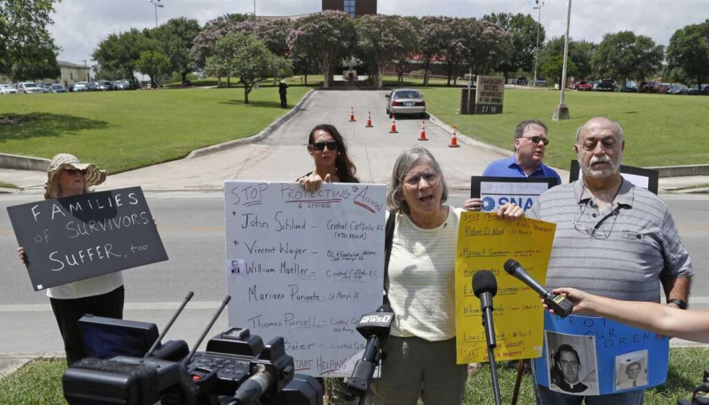 Patty Koo and Zac Zepeda, on her right, talk to media as the Survivors Network of those Abused by Priests call for action by Archbishop of San Antonio Gustavo García-Siller and St. Mary’s University President Thomas Mengler during a news conference outside the Archdiocese of San Antonio on Wednesday.  Ronald Cortes /Contributor