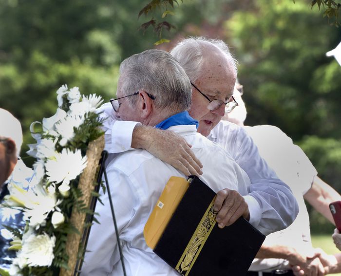 Joe Croteau, left, hugs Retired priest Rev. James Scahill after Scahill spoke at held a graveside memorial service for Joe's little brother Danny, the 13-year-old altar boy authorities determined was killed by his parish priest in 1972. (Don Treeger / The Republican) 6/28/2021