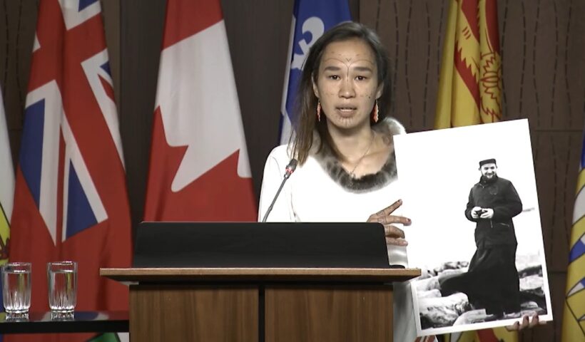 Nunavut MP Mumilaaq Qaqqaq holds a photo Thursday morning of French Oblate priest Joannis Rivoire, who is accused of sexually assaulting Inuit children who attended residential schools in Nunavut communities in the 1960s. The NDP is calling on the government to investigate Rivoire and other alleged perpetrators within the residential school system. (Screen grab courtesy of CPAC)