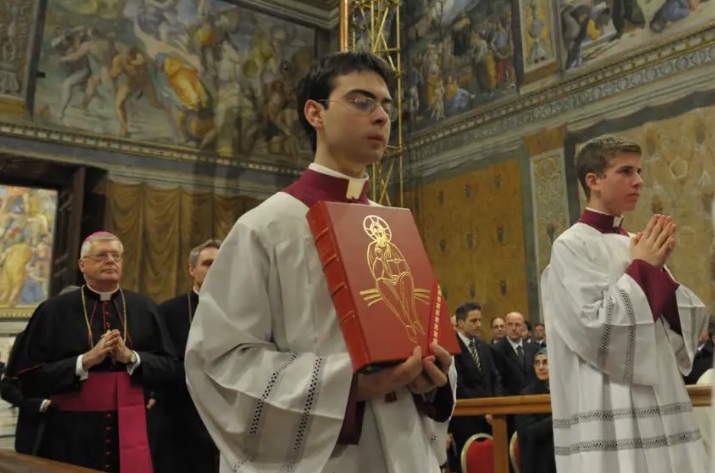 Martinelli holds a missal during the newly-elected Pope Francis' first Mass inside the Sistine Chapel on March 14, 2013. (Vatican Media)