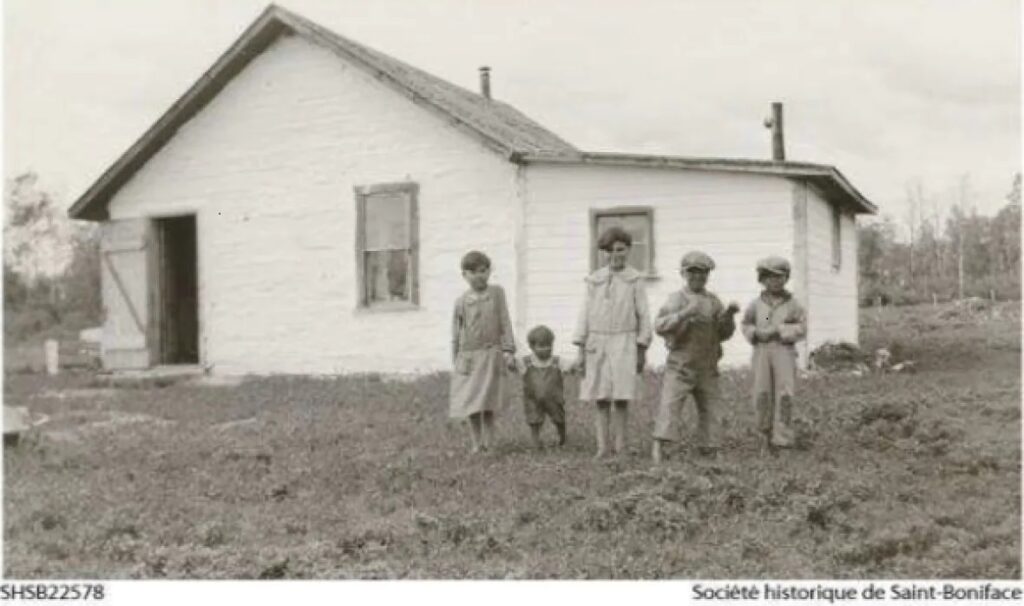 Indigenous boys in front of the St. Philip's Indian Residential School in the 1930s before the school was expanded. (Société historique de Saint-Boniface)