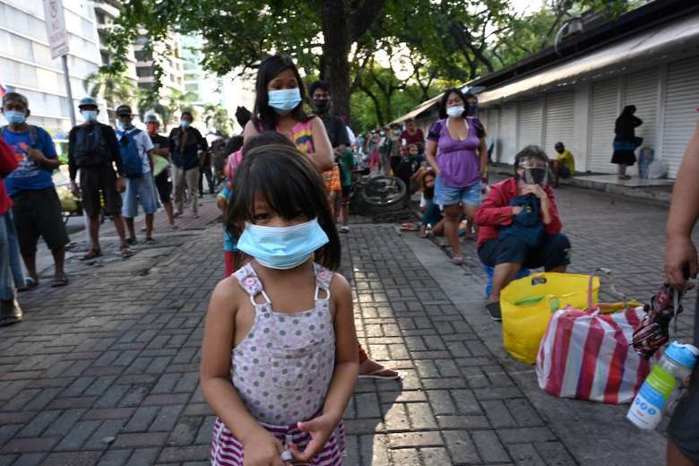 Street dwellers including children queue for free food distributed by the Society of the Divine Word in Manila. The pandemic has brought an increase in the sexual abuse of children in the Philippines. (Photo: AFP)