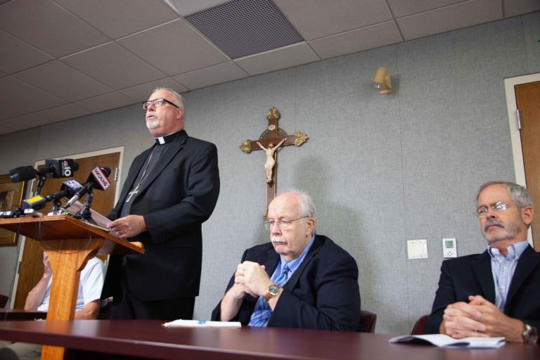 From left, Bishop Christopher Coyne and members of the church’s lay committee, Mike Donoghue and Mark Redmond. Photo by Mike Dougherty / VTDigger