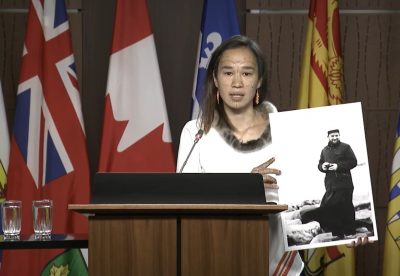 [Nunavut MP Mumilaaq Qaqqaq holds a photo of French Oblate priest Joannis Rivoire, who is accused of sexually assaulting Inuit children who attended residential schools in Nunavut communities in the 1960s. The NDP is calling on the government to investigate Rivoire and other alleged perpetrators within the residential school system. (Screenshot courtesy of CPAC)]