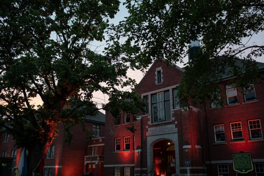 The former Kamloops Indian Residential School in British Columbia is lit with orange lights, in honor of the children whose bodies were discovered there. Amber Bracken for The New York Times