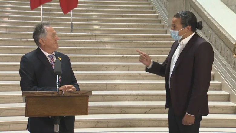 Manitoba NDP Leader Wab Kinew confronts Alan Lagimodiere on July 15 over the newly appointed Indigenous reconciliation minister's comments about the residential school system. (Global News Pool Feed )