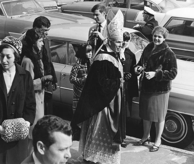 In this file photo from 1968, Bishop Fulton J. Sheen, center, greets some Peoria friends shortly after celebrating Mass at St. Patrick's Church while commemorating the parish's 100th anniversary. - C. MERCER/JOURNAL STAR FILE