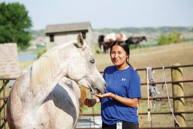 Equine therapy is a major part of St. Joseph’s approach. The students brush and paint the horses, walk with them throughout campus, and even bring them to meetings. Courtesy of St. Joseph’s Indian School.