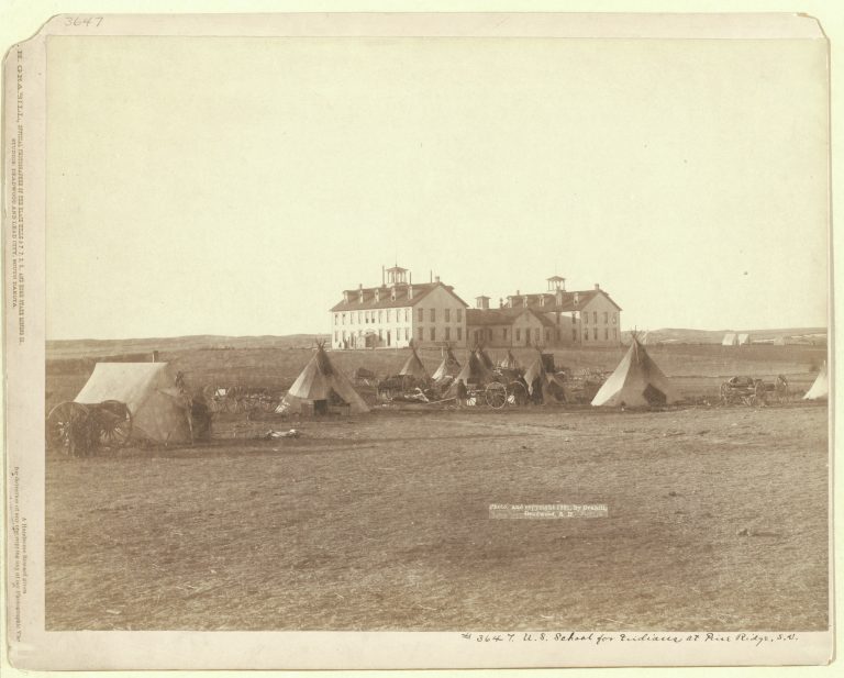 In 1888, Jesuits and Franciscan sisters came to Pine Ridge and built Holy Rosary Mission. In 1969, the school was officially renamed Red Cloud Indian School, after the Lakota chief who brought the Jesuits to Pine Ridge. Credit: Library of Congress, Prints and Photographs Division, John C. H. Grabill Collection