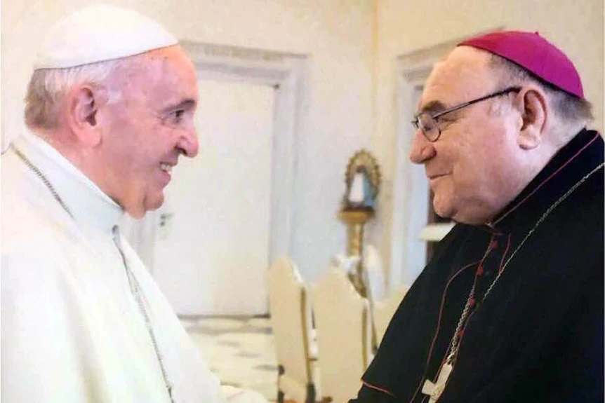 Bishop Christopher Saunders, pictured here with Pope Francis, stood aside from his duties in March last year, when allegations of sexual misconduct were made public.(Supplied)