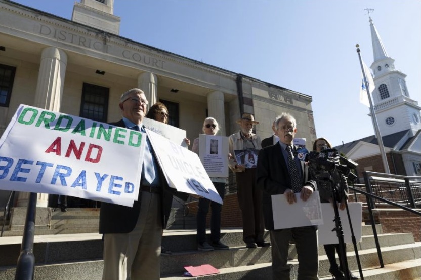 Members of BishopAccountability.org hold a news conference outside Dedham District Court following the arraignment of former Cardinal Theodore McCarrick, Friday, Sept. 3, 2021, in Dedham, Mass. McCarrick has pleaded not guilty to sexually assaulting a 16-year-old boy during a wedding reception in Massachusetts nearly 50 years ago. (AP Photo / Michael Dwyer)