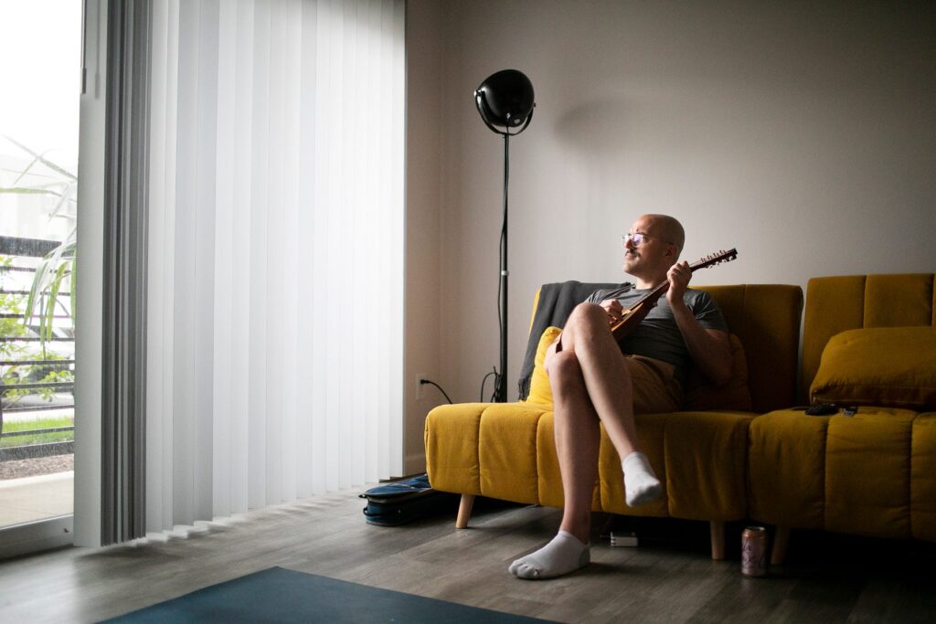 Chris Graham plays a mandolin at home in Westerville after an intense Eye Movement Desensitization and Reprocessing (EMDR) psychotherapy session. Therapy has helped Graham recover repressed memories of being raped by a Columbus priest when he was 14 years old. COURTNEY HERGESHEIMER/COLUMBUS DISPATCH