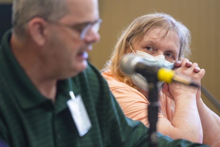 Katelin Hoffman, a member of The Voices of St. Joseph’s Orphanage and a survivor of abuse when at the orphanage as a child, listens as fellow survivor Michael Ryan speaks. Photo by Glenn Russell/VTDigger