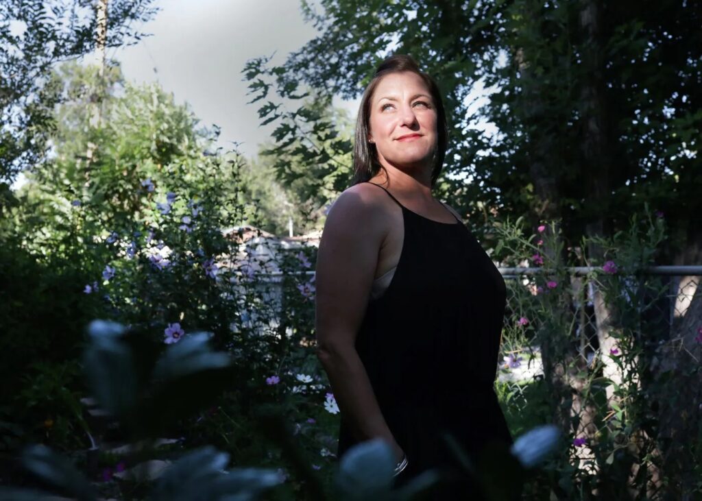 Jules Woodson poses for a photo at her home in Colorado Springs, Colo., in August. (Rachel Ellis for The Washington Post)