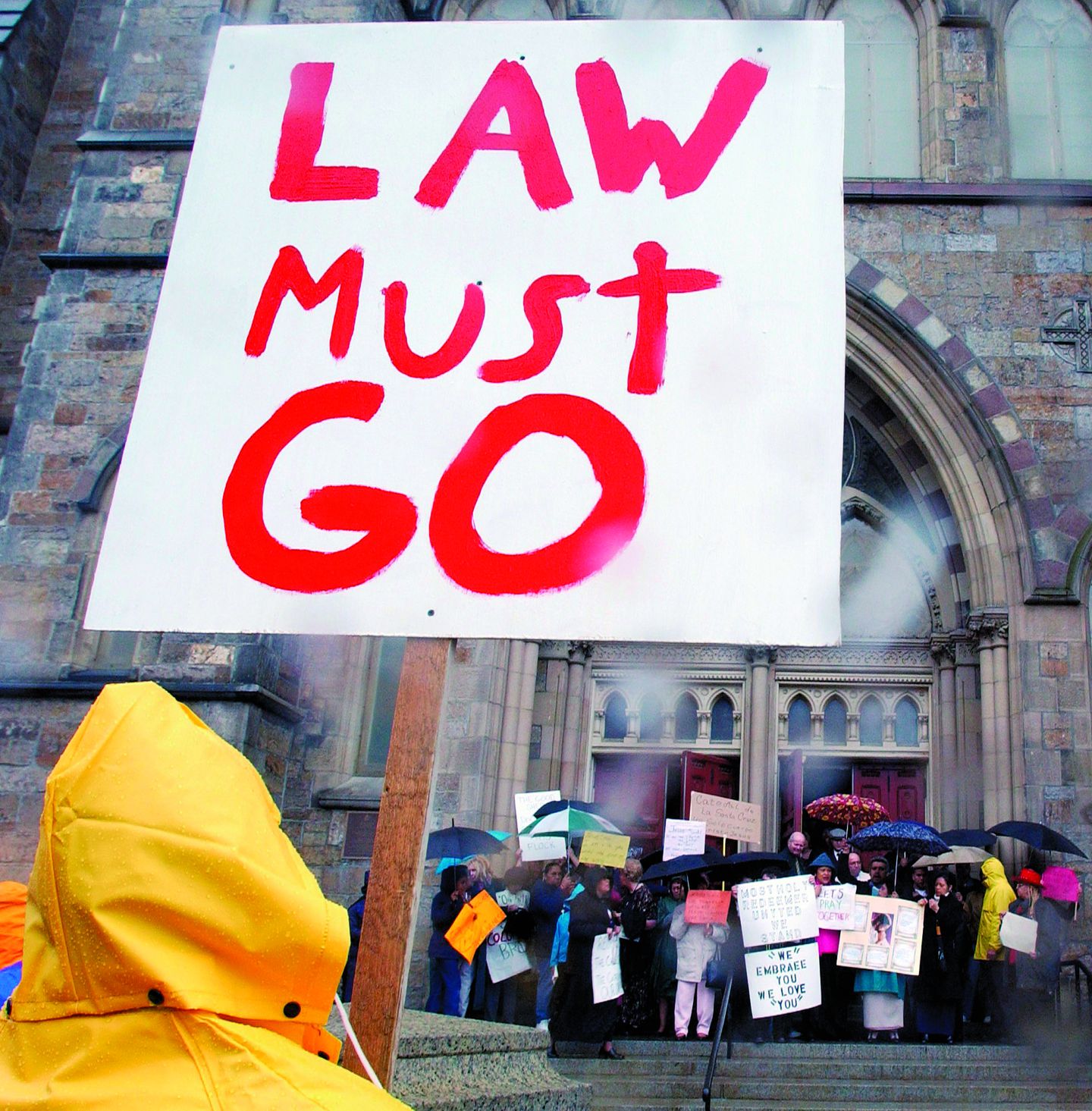 A man protesting against Cardinal Bernard Law faces a group of pro-Law protesters on the steps of the Cathedral of the Holy Cross in Boston in April 2002.MICHAEL DWYER/AP/FILE