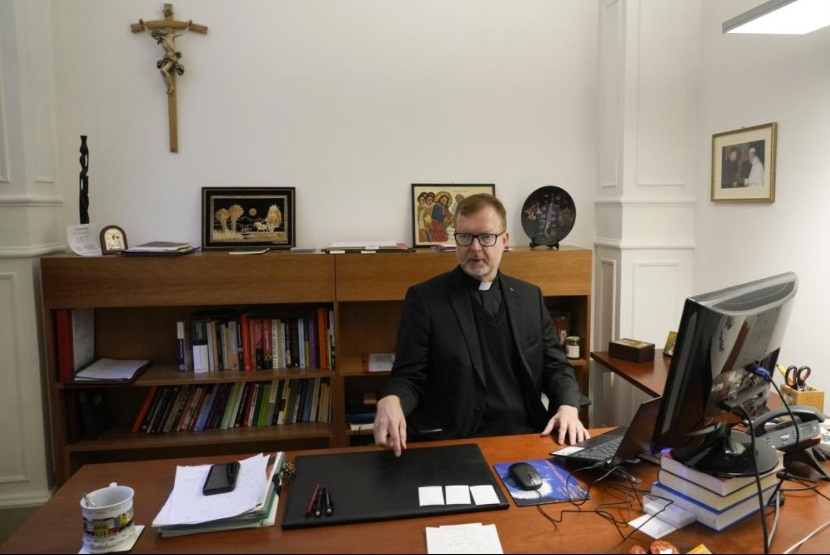 Hans Zollner, head of the new safeguarding institute at the Pontifical Gregorian University, sits in his office before an interview with the Associated Press, in Rome, Wednesday, Oct. 13, 2021. The Catholic Church’s foremost research and training institute into clergy sexual abuse of minors is expanding its mandate to also include the sexual and spiritual abuse of adults, evidence that the Vatican is increasingly aware that children aren’t the only victims of clergy who abuse their power and authority. (AP Photo / Alessandra Tarantino)