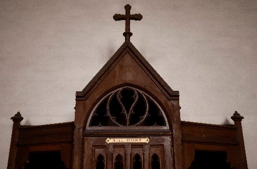 A confessional on which is written: "M. the Priest" is pictured in a Catholic church near Nantes, France, Oct. 5, 2021. Church and government leaders in France are at odds over whether priests should be required to report the abuse of minors if they learn about it in the sacrament of confession. (CNS photo / Stephane Mahe, Reuters)