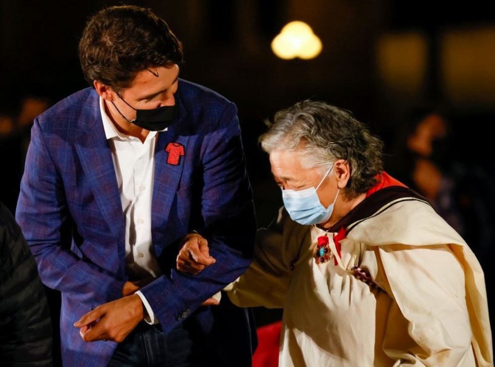 Canadian Prime Minister Justin Trudeau escorts Elder Levinia Brown on Parliament Hill in Ottawa Sept. 29, 2021, the eve of Canada's first National Day for Truth and Reconciliation. The day honored the lost children and survivors of Indigenous residential schools, their families and communities. (CNS photo / Blair Gable, Reuters)