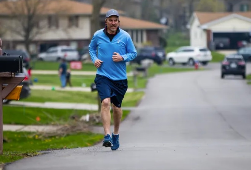 Saint Joseph High School Principal John Kennedy runs in his northside neighborhood. He previously ran a mile for each of the seniors in the school. Tribune File Photo