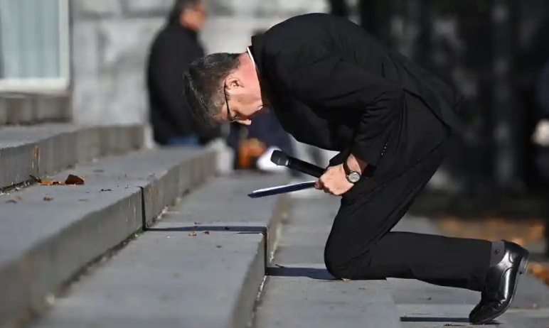 Archbishop of Reims Eric de Moulins-Beaufort kneels during a ceremony at the sanctuary of Lourdes. Photograph: Valentine Chapuis / AFP / Getty Images