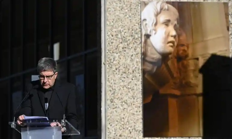 Eric de Moulins-Beaufort, Archbishop of Reims, in front an artwork showing a sculpture representing the head of a weeping child. Photograph: Valentine Chapuis / AFP / Getty Images