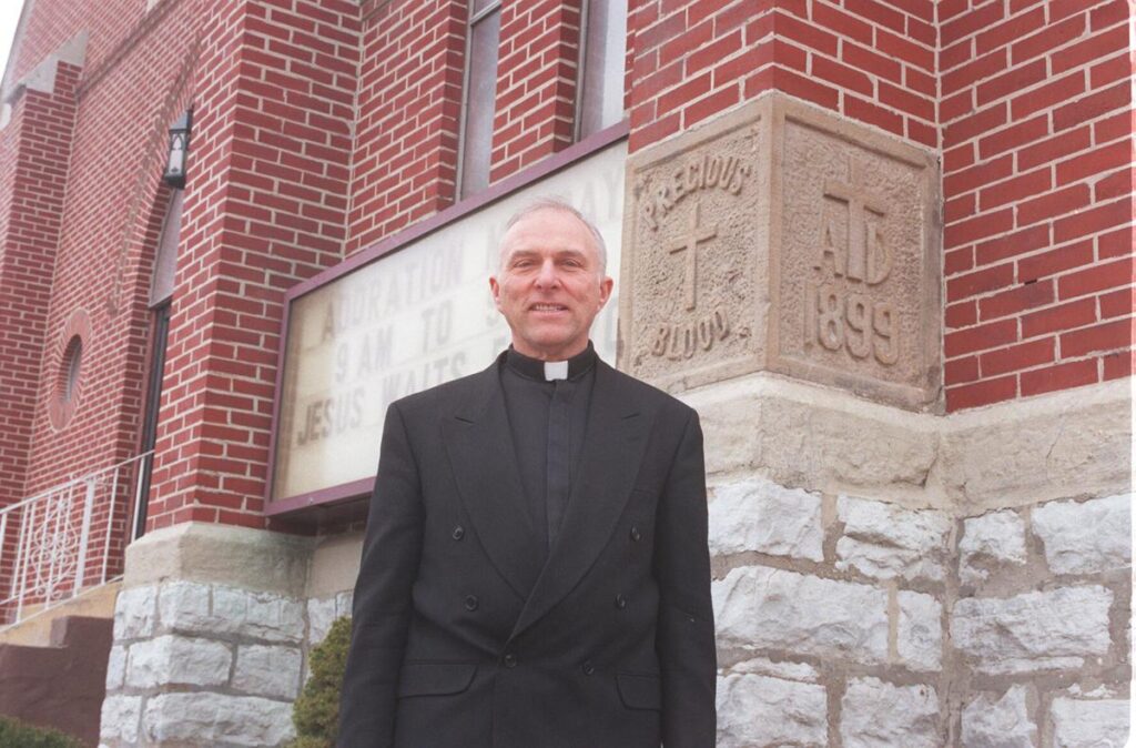 Monsignor Ronald P. Sciera stands outside Precious Blood Church in Buffalo in 1999.   John Hickey/News file photo