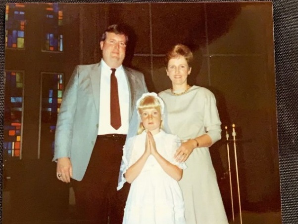 Julie Krommer (middle) flanked by her parents at her First Communion at St. Ignatius of Loyola Church (Provided: Julie Krommer)