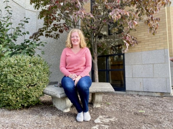 Julie Krommer sits outside St. Ignatius of Loyola Church. She's attended Mass there her entire life. (Spectrum News / Casey Weldon)