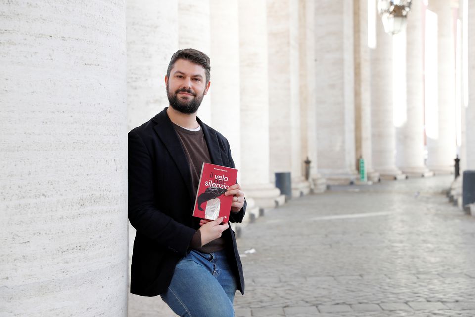 Salvatore Cernuzio, author of a new book, Veil of Silence, that chronicles episodes of psychological, emotional and physical abuse of Catholic nuns in convents, poses for a photograph among the colonnades in Saint Peter's Square, at the Vatican, November 24, 2021. Picture taken November 24, 2021. REUTERS/Remo Casilli
